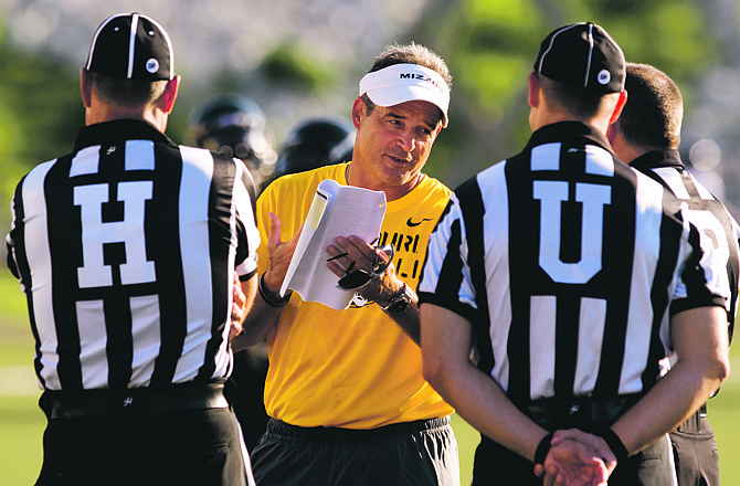 Missouri head coach Gary Pinkel talks with referees prior to the start of an NCAA college football scrimmage Saturday, Aug. 13, 2011, in Columbia. Mo.  (AP Photo/L.G. Patterson)