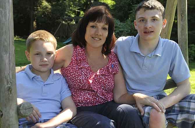 Kathleen Lanese of Kings Park, N.Y., with her two autistic sons Kevin, 10, left, and Brendan, 14, at her sister-in-law's home on Thursday, Aug. 11, 2011, in Oyster Bay, N.Y. Lanese says having one son with autism didn't make her think twice about trying to have another child, even though she knew there was a chance the second would be affected, too.