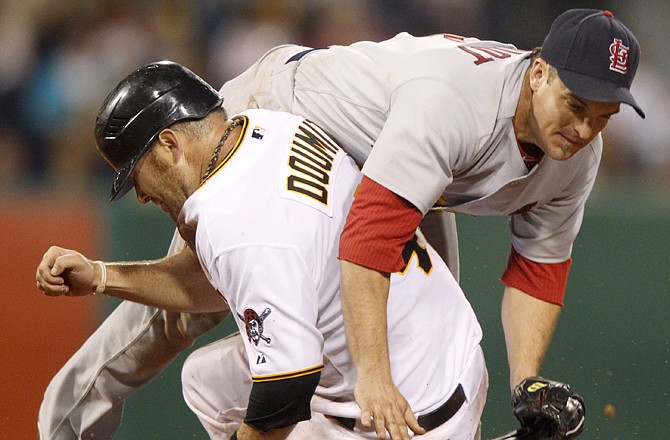 Ryan Doumit of the Pirates runs into Cardinals second baseman Ryan Theriot after being forced out at second during the eighth inning of Monday night's game in Pittsburgh.