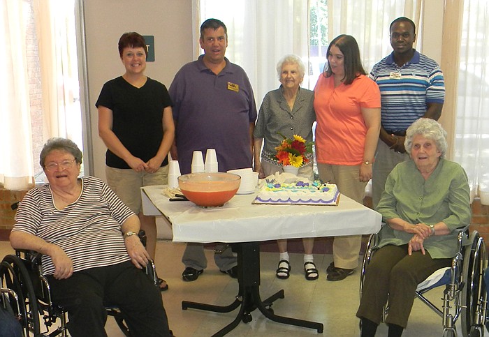 Several residents and employees with new California Care Center employees who were treated to a cake and punch reception Tuesday, Aug. 9; front row, from left, are residents Alice Milligan and Laverne Birdsong; back row, new beautician Mellisa Weis, Director George Freiner, resident Marion Tilton, Occupational Therapist Heather Wolfe (OT R/L), Physical Therapy Assistant Aeriel Currithers (PTA).  New physical therapist Pam Monroe (PT) was not present.