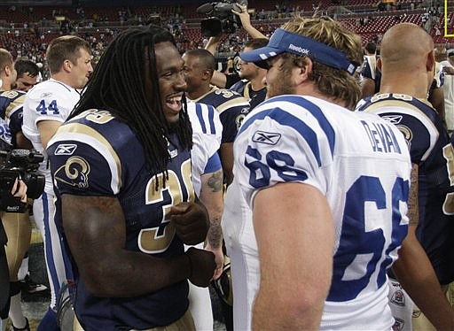 Rams running back Steven Jackson (left) talks with Colts offensive lineman Kyle DeVan after Saturday's preseason game in St. Louis. Jackson didn't play in the Rams' 33-10 win.