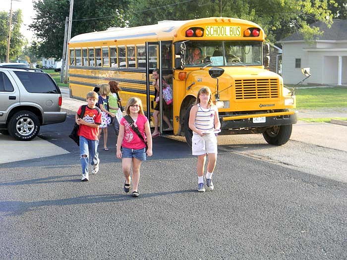 Students get off the bus on their first day of school at Jamestown C-School Wednesday, Aug. 17, 2011.