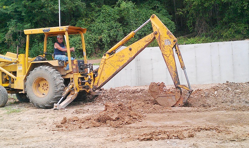 Charlie Schmid works to move dirt at the site of the new Portland Community Building Wednesday afternoon. Community Association officials say they have the funds to put up the exterior of the new structure, but not to complete the project. The original building burned down on Aug. 13, 2010.