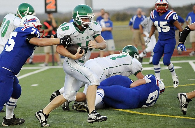 Blair Oaks' Derek Otto tries to shed a Moberly tackler during Friday's Jamboree at the Falcon Athletic Complex.
