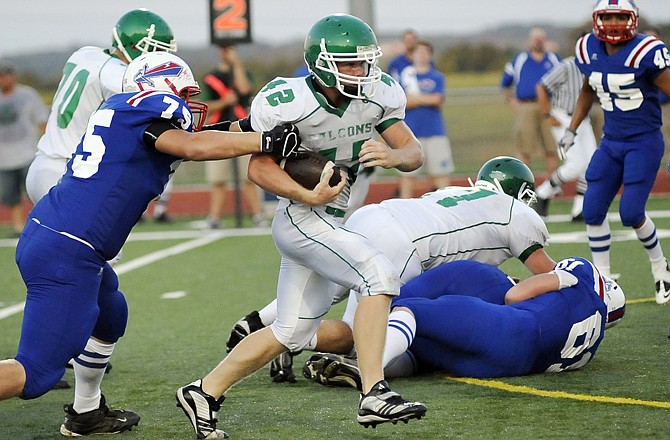 Blair Oaks Derek Otto carries the ball at the Blair Oaks Jamboree Friday evening at the Falcon Athletic Complex. Otto had 10 carries for 55 yards. 