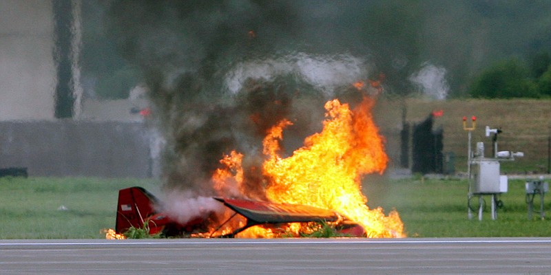 Remains of a fiery crash that killed a stunt pilot who couldn't pull out of a downward spiral are seen during the Kansas City Air Expo Air Show at the Kansas City Wheeler Downtown Airport, Saturday, Aug. 20, 2011, in Kansas City, Mo. Aviation Department spokesman Joe McBride says the biplane crashed Saturday into the grass at a downtown airport airfield. Event officials identified the pilot as Bryan Jensen, though no other information was released. (AP Photo/The Kansas City Star, Rich Sugg)