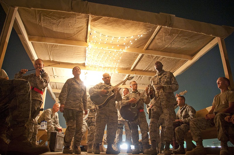 This Aug. 10, 2011 photo shows Staff Sgt. Angie Johnson, standing second from left, and members of the 571st U.S. Air Force Central Command Expeditionary Band "Sidewinder" performing for military members at Kandahar Airfield, Afghanistan, Aug. 10, 2011. Video of the band's acoustic cover of Adele's hit song "Rolling in the Deep," has made the band a viral hit with nearly 1 million views online in less than a month. The band is a part of Missouri Air National Guard and is deployed from the 131st Bomb Wing. (AP Photo/Senior Airman Corey Hook - US Air Force)