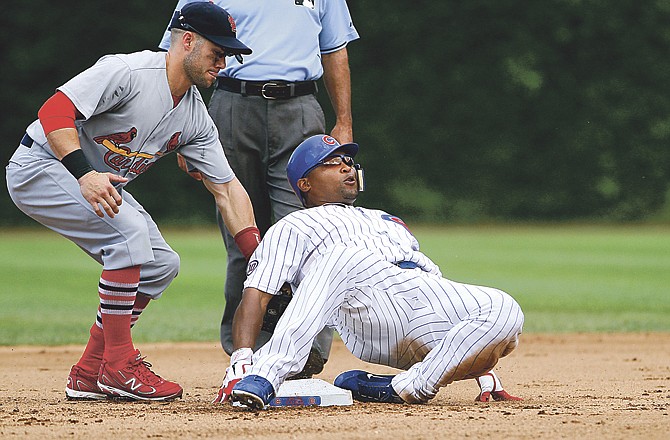 Chicago Cubs' Marlon Byrd slides safely into second base with a double while the St Louis Cardinals second baseman Skip Schumaker is late with the tag in the fourth inning of a baseball game on Saturday Aug. 20, 2011 in Chicago.