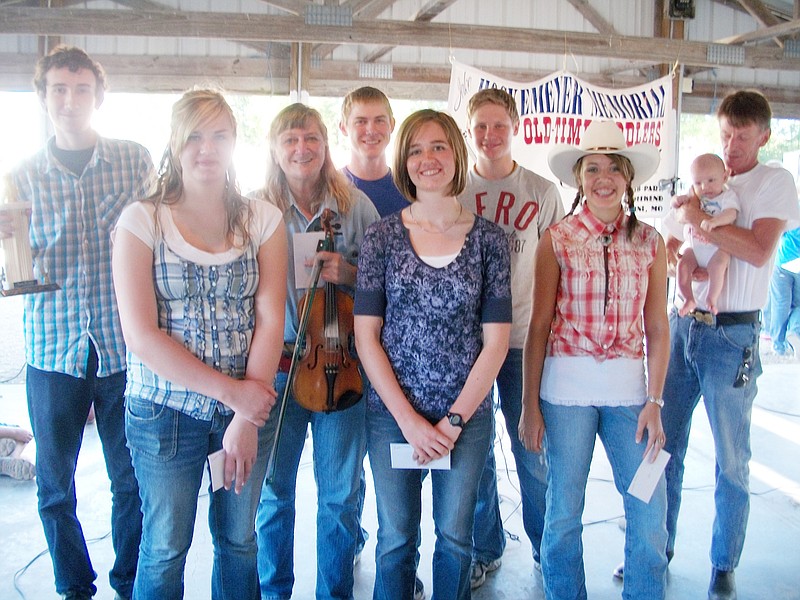 (From left) Competitors in the open division of the Jake Hockemeyer Memorial Old Time Fiddler's Contest were Richard Shewmaker of Columbia, Joanna Coleman of Schell City, Kathy Summers of Bourbon, Zach Benson of Schell City, Sadie Curry of Columbia, Andrew Coleman of Schell City, Ashley Monasmith of Pacific and Lynn Wells (with his grandson) of Boonsboro. This year's contest will start at 3 p.m. on Sept. 4. There are $800 in cash prizes up for grabs, with a $20 show-up fee for all fiddlers who do not place in money.