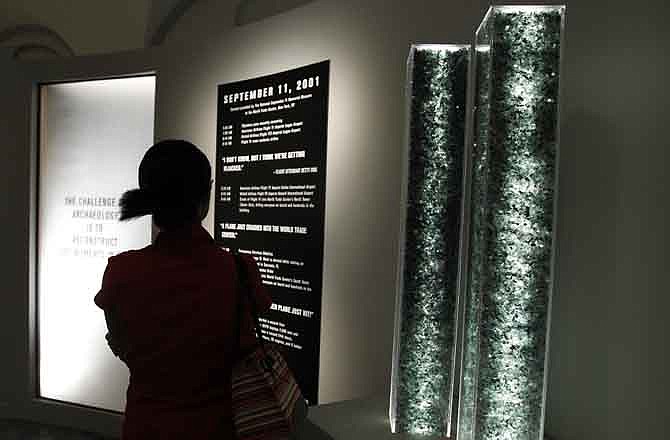 A woman looks at an exhibit Excavating Ground Zero: Fragments from 9/11, at the University of Pennsylvania Museum of Archeology and Anthropology, during a media preview Friday, Aug. 19, 2011, in Philadelphia. The exhibit runs August 20 through November 6, 2011. 