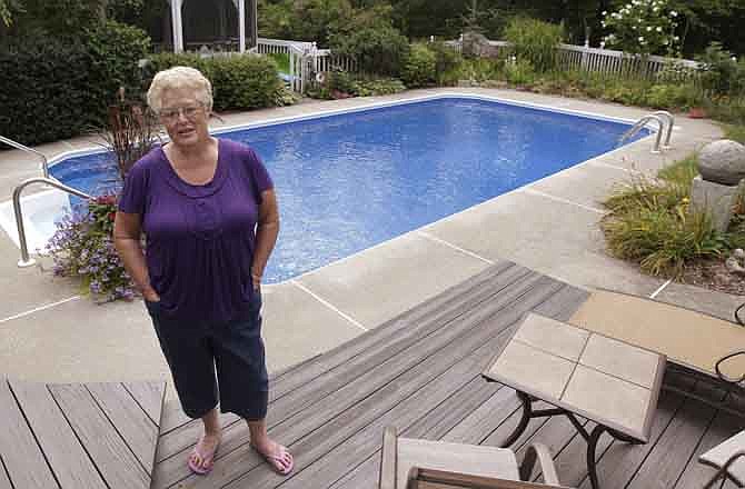 In this photo taken Aug. 19, 2011, Linda Tisch poses in her back yard at her home in Westerley, R.I. Tisch suffered a heart attack on Saturday Aug. 13, 2011, was treated in a record 16 minutes and is returning to work today just 10 days after treatment.