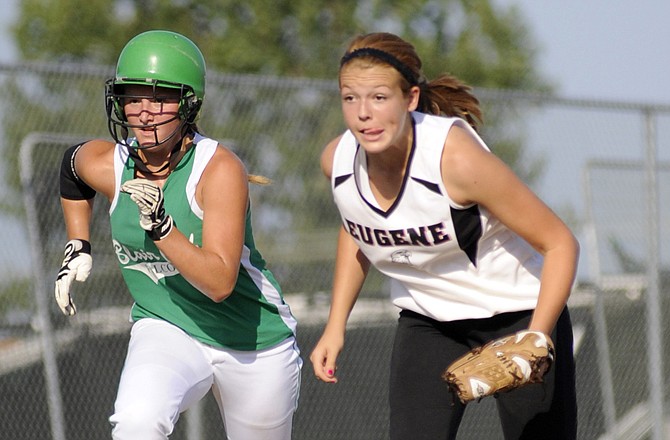 Macy Reinkemeyer of Blair Oaks races for home as Eugene third basemen Ashton Bernskoetter charges in to field a bunt during Tuesday's game in Wardsville.