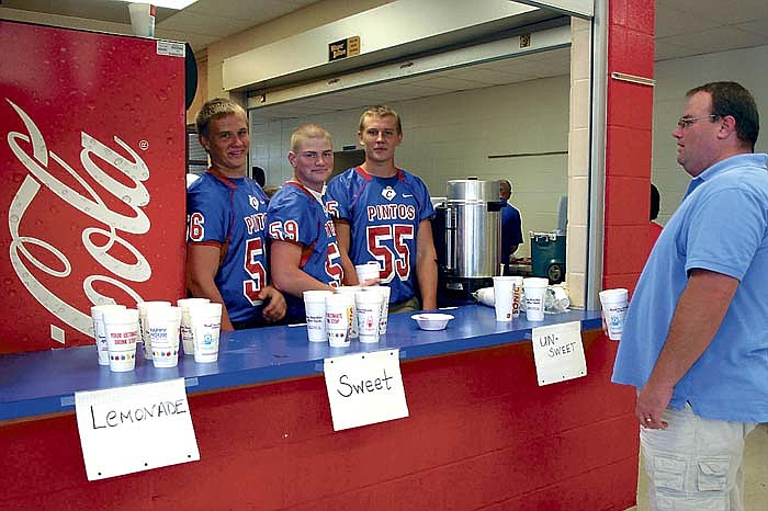 Pinto football players serve drinks at the Pinto Quarterback Club's annual barbecue Sunday, Aug. 19, at California High School. 