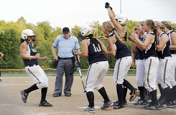 Taylor Pritchett is greeted by her Helias teammates after hitting a home run during Tuesday night's game against Jefferson City at Duensing Field.