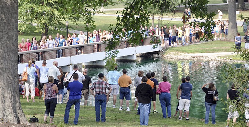 During a traditional Ivy Ceremony, new William Woods University students cross the Senior Lake Bridge while family and friends watch. When they graduate, they will cross the bridge through the ivy in the opposite direction.