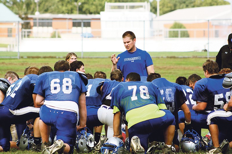 South Callaway head coach Tim Rulo talks with his varsity squad toward the end of Wednesday's practice at the high school in Mokane. The Bulldogs - coming off their 2010 milestone season - open the 2011 campaign at Fayette at 7 tonight.