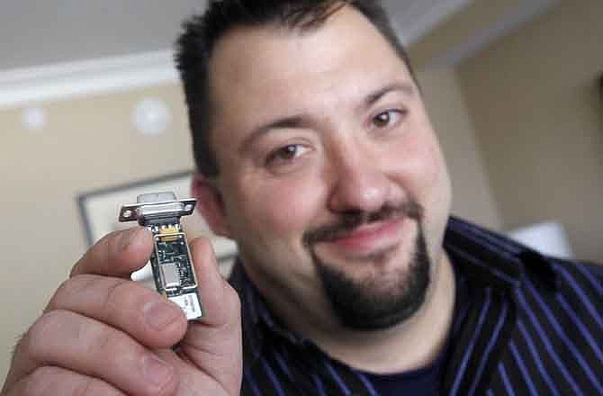 In this file photo taken Aug. 4, 2011, Jay Radcliffe, displays a radio device he uses to perform an attack on an insulin pump and taking control of the device wirelessly, at the annual Black Hat conference for digital self defense, in Las Vegas.