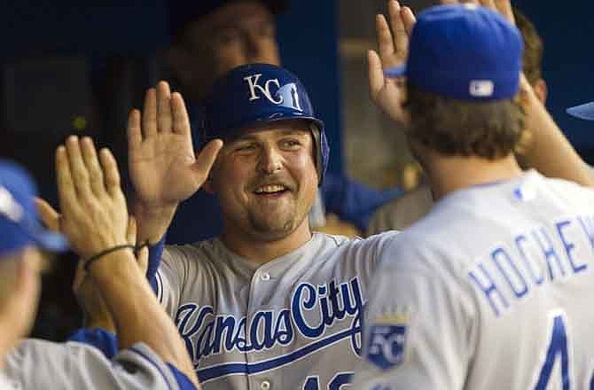 Kansas City Royals' Billy Butler, center, celebrates after scoring on a Mike Moustakas RBI-single in the fourth inning of MLB baseball action against the Toronto Blue Jays in Toronto, Thursday, Aug. 25, 2011.