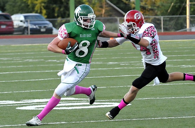 Blair Oaks receiver Tanner Kemna breaks a tackle against Carrollton Friday night at the Falcon Athletic Complex.