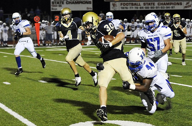 Helias running back Brendan Roberts runs after a catch in the third quarter against Harrisonville on Friday night at Adkins Stadium.