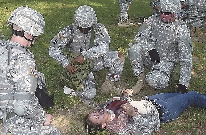 
Sgts. Delvin Willis, center, and Craig Lueckenotto, both of Headquarters and Headquarters Detachment, 835th Combat Sustainment Support Battalion, evaluate a burn victim during training at Camp Clark in Nevada. 