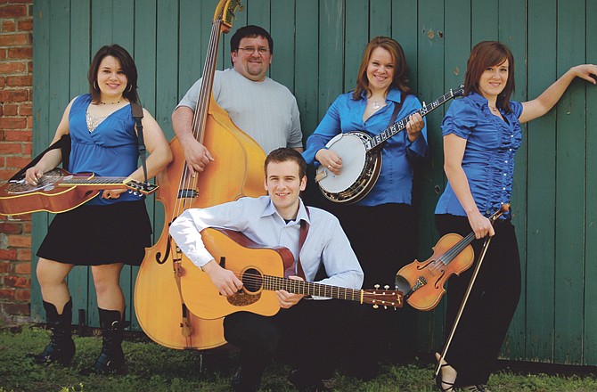 The award-winning Martin Family, a Jefferson City-based bluegrass band started 10 years ago in Versailles, will headline entertainment Sept. 11 at the annual Bluegrass & Barbecue Festival on the lawn of the Fulton State Hospital in Fulton, Mo. In front is Dale Martin. Others, from left, are: Larita Martin, Elvin Martin, Janice Martin, and Jeana Martin Faris. 