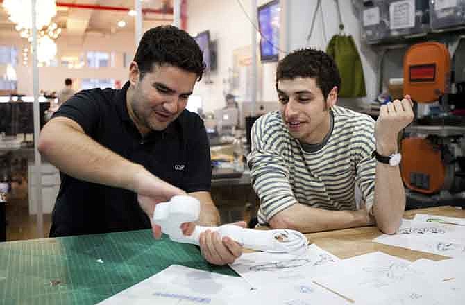 In this image released by the Sundance Channel, Ben Kaufman, founder and CEO id Quirky, left, and Jake Zien are shown working on Zien's product, an adjustable power strip called Pivot Power, in a scene from the original series, "Quirky." The series premieres Aug. 30, 2011 at 10 p.m. EST on Sundance Channel.