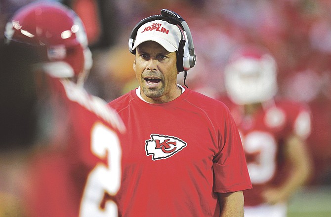 Kansas City Chiefs coach Todd Haley talks with punter Dustin Colquitt (2) during the first half of a preseason NFL football game against the St. Louis Rams at Arrowhead Stadium in Kansas City, Mo., Friday, Aug. 26, 2011.  