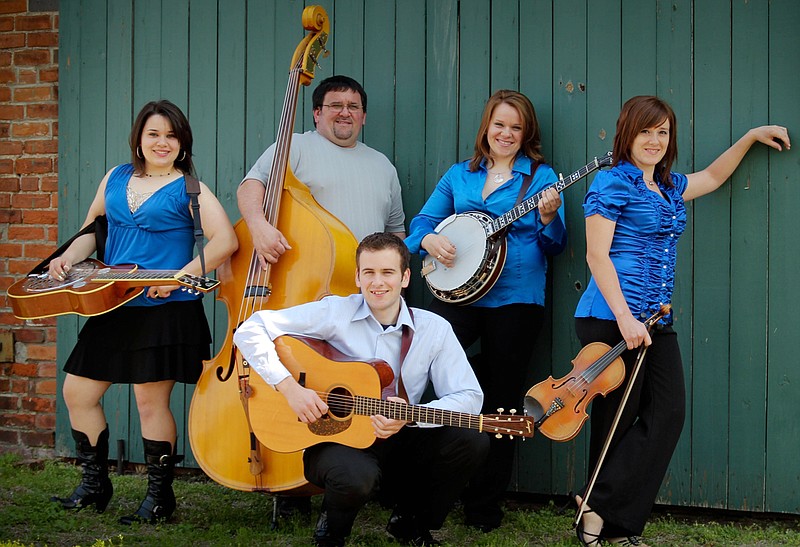 The award-winning Martin Family, famed Jefferson City bluegrass band started 10 years ago in Versailles, will headline entertainment Sept. 11 at the annual Bluegrass & Barbecue Festival on the lawn of the Fulton State Hospital in Fulton. In front is Dale Martin. Others, from left, are: Larita Martin, Elvin Martin, Janice Martin, and Jeana Martin Faris.