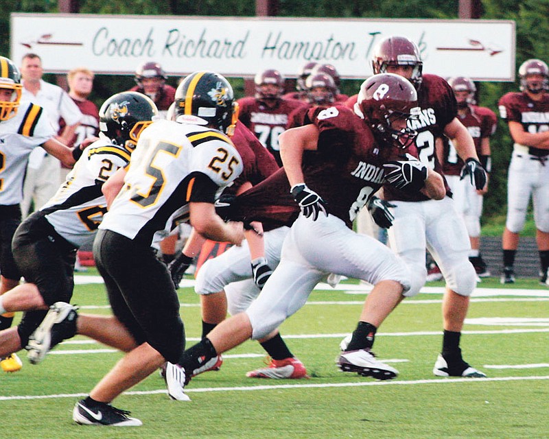 School of the Osage senior wide receiver Jared Edwards tries to free himself from the grasp of a Fulton defender on a first-quarter run in Friday night's season opener at Osage Beach. Edwards returned two punts for scores and ended up with four touchdowns overall in the Indians' 54-0 dismantling of the Hornets.