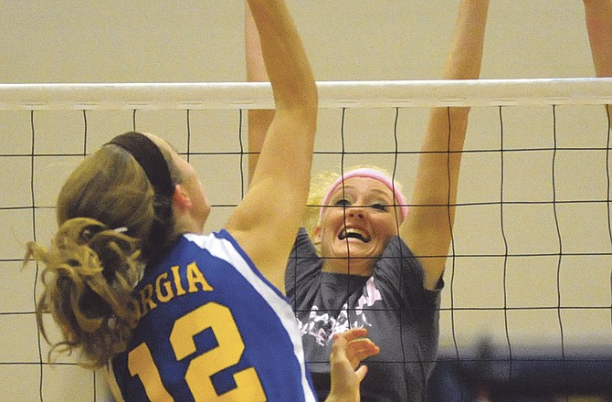 Helias' Krista Haslag goes up for a block in a match with St Francis Borgia last season at Rackers Fieldhouse. Haslag, an all-region performer last year, and the Lady Crusaders will open their schedule tonight at home against Sedalia Smith-Cotton. 