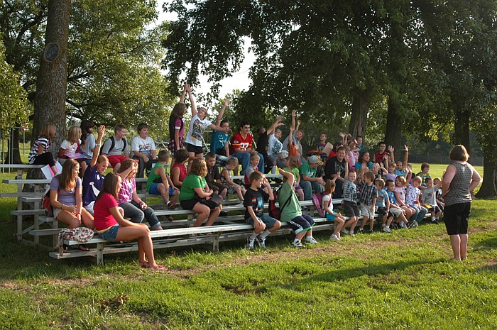 The Latham School first day assembly is held on bleachers in the shade.