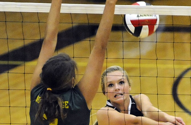 Sloan Pleus sends the ball over the net during Jefferson City's win over Rock Bridge on Tuesday at Fleming Fieldhouse.