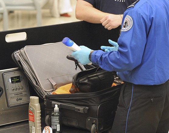A Transportation Security Administration checks a passenger's carry-on luggage in August at the security checkpoint at Hartsfield-Jackson Atlanta International Airport in Atlanta. The federal government is escalating security around the country in preparation for the 10th anniversary of the 9/11 terrorist attacks.