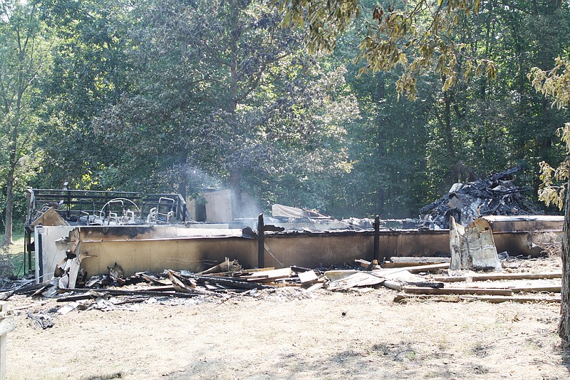 The remains of Michael Wieberg's home on County Road 1027 near Auxvasse still give off smoke Saturday morning. Two bodies were found in the wreckage of the home - which burned early Friday morning. Although identification was not definite, officials said Saturday they believe the bodies to be those of Wieberg, 56, and his daughter, Amanda Wieberg, 33.