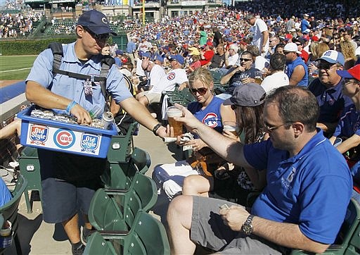 In this photo taken Aug. 25, 2011, a vendor sells an Old Style beer to a fan during a Chicago Cubs baseball game at Wrigley Field in Chicago. Pabst Brewing Company is thinking about pulling Old Style from Wrigley after 61 years. In a city of refining tastes, many fans at Wrigley still wouldn't think of drinking anything but Old Style.