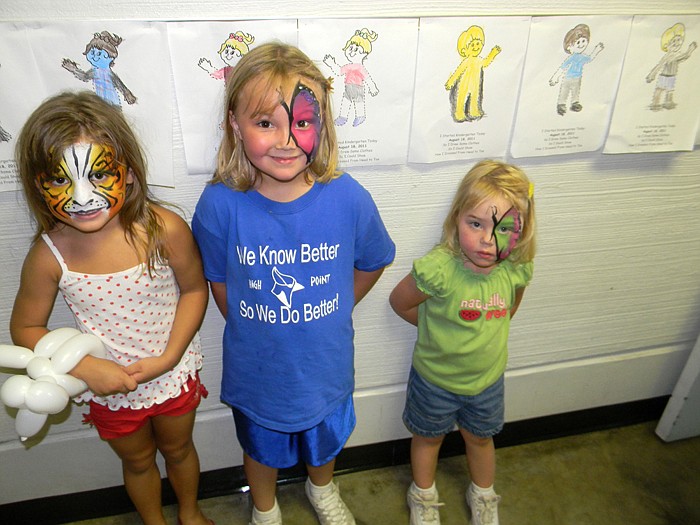 From left; Zoey Percival, Jillian and Jada Schmidt had their faces painted by the Kingdom Klowns at the High Point Homecoming.