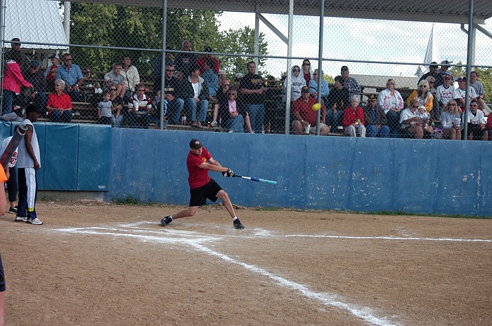 Windy Ridge batter Jared Auch makes a hit at the Labor Day weekend softball tournament on Monday. 