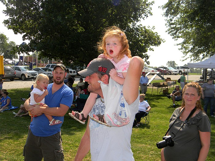 Carlee Hull, on father Daniel Hull's shoulders yells "Woo!" during the High Point Homecoming Parade while Grayson Hohman is held by father Jamie Hohman.