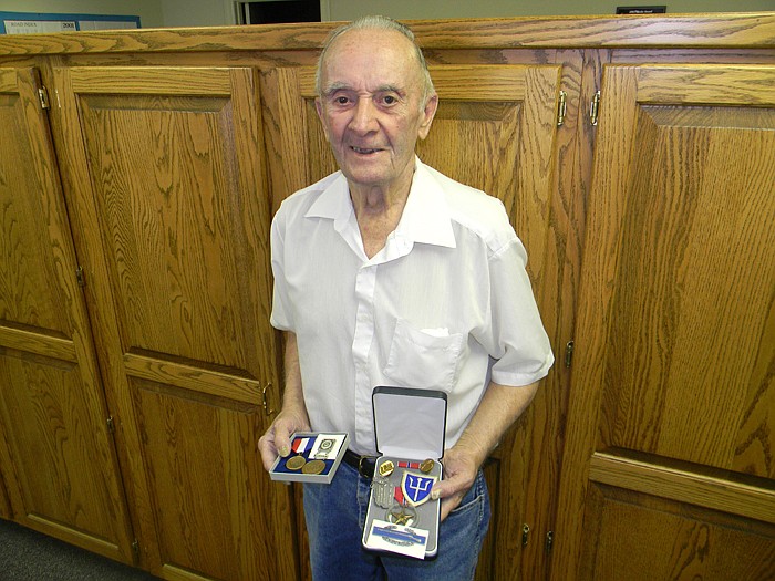 Alvin "Sam" R. Bonecutter with his Bronze Star and Combat Infantry Badge he earned for his actions during conflicts in Germany during World War II.