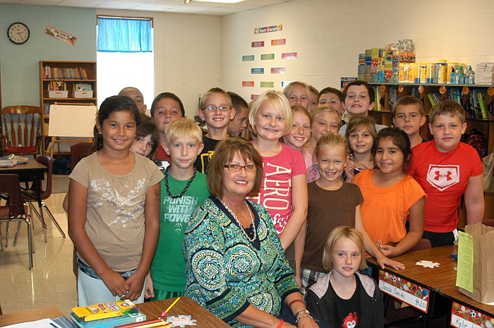 Cheryl Gosnell, shown surrounded by students, is an ESOL teacher at California Elementary School.