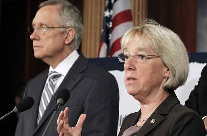 In this July 27, 2011, file photo, Sen. Patty Murray, D-Wash., speaks as Senate Majority Leader Harry Reid listens at a news conference on Capitol Hill in Washington. Reid announced Tuesday, Aug. 9, 2011, he's naming to co-chair a powerful "super committee" charged with finding more than $1 trillion in deficit cuts this fall. Murray will be joined by Sens. John Kerry, D-Mass., and Max Baucus, D-Mont., on the panel. 