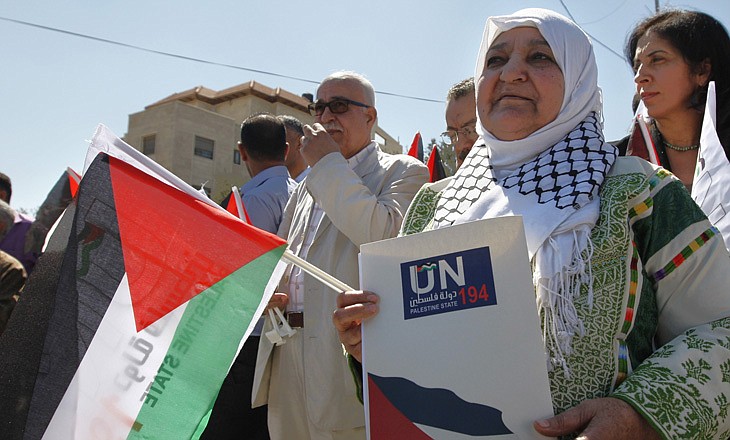 Palestinian activist Latifa Abu Hmeid holds a letter Thursday addressed to the UN Secretary-General Ban Ki-moon in front of the UN headquarters in the West Bank city of Ramallah. The Palestinians on Thursday officially launched their campaign to join the United Nations as a full member state, saying they would stage a series of peaceful events in the run-up to the annual gathering of the U.N. General Assembly later this month.