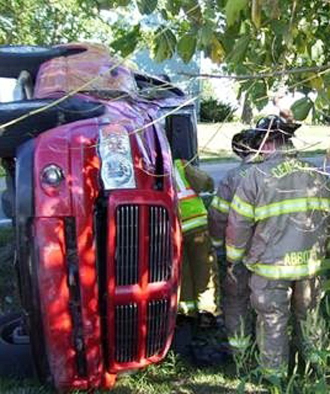 Central Fire Protection District firemen extricate Stephen Randall Vaughan of Jefferson City from his pickup truck that overturned Tuesday afternoon on Route O just south of Fulton.