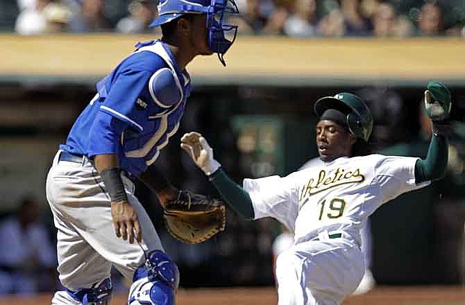 Oakland Athletics' Jemile Weeks, right, slides to score as Kansas City Royals catcher Salvador Perez waits for the ball during the sixth inning of a baseball game on Wednesday, Sept. 7, 2011, in Oakland, Calif. Weeks scored on a single by Hideki Matsui, of Japan. 