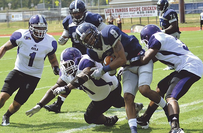 Corderious Gregory of Lincoln tries to find running room during last Saturday's game against Avila at Dwight T. Reed Stadium.