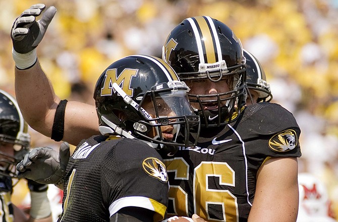 Missouri lineman Austin Wuebbels congratulates quarterback James Franklin after Franklin scored a first-quarter touchdown last Saturday against Miami of Ohio at Faurot Field.