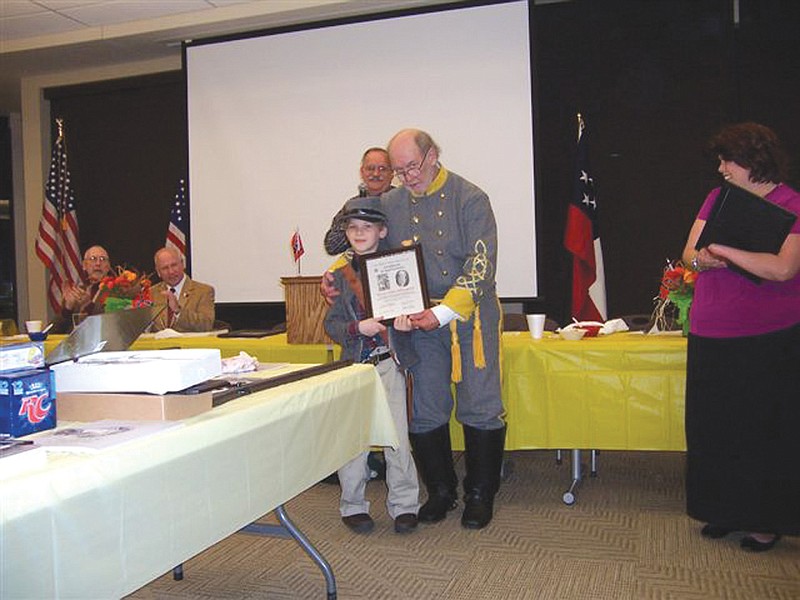 The late James Harrison presents Billy Dillingham, 9, a certificate of appreciation for his service as mascot to the Elijah Gates Camp Color Guard during the group's annual Fall Muster in November 2010. This year's muster, to be held on Oct. 8 at the Callaway Electric Cooperative, will include a tribute to Harrison, who died in July.