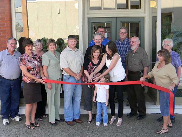 Members of the California Area Chamber of Commerce, family and friends help Commonsense Coalition Talk Radio Partners Beth Schoeneberg, left, and Kay Connell, right, cut the ribbon on their new business.