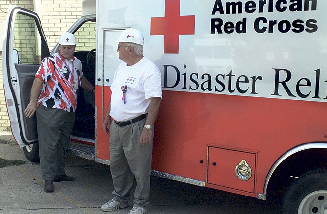 Steve Stacey (left) and Gene Lawson prepare supplies inside the vehicle they took to New York City to help with disaster relief in 2001. (File photo)